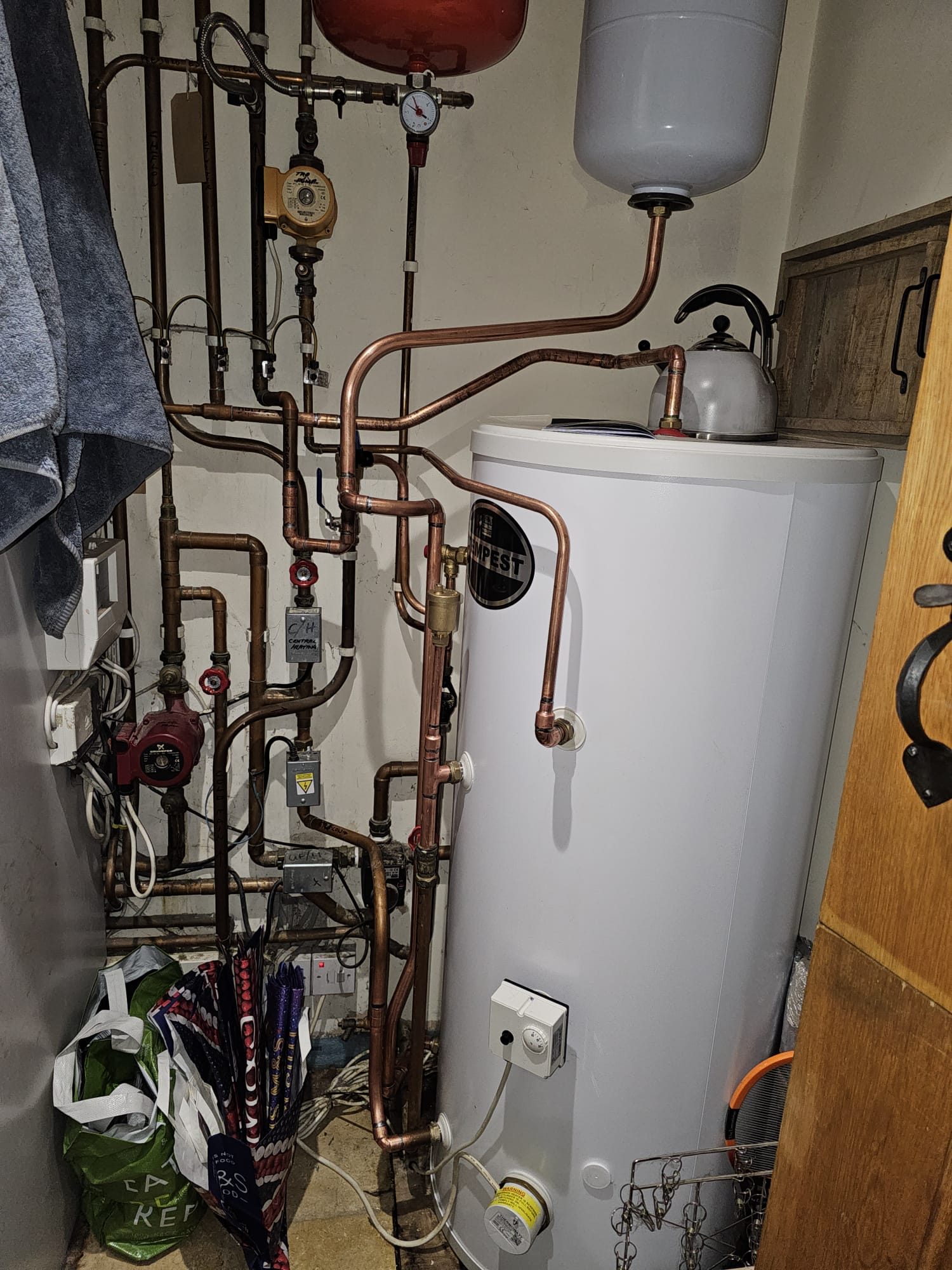 Detailed copper pipework on a hot water cylinder